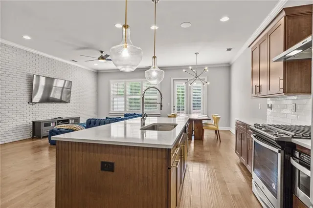 a kitchen with a table chairs stove and wooden floor