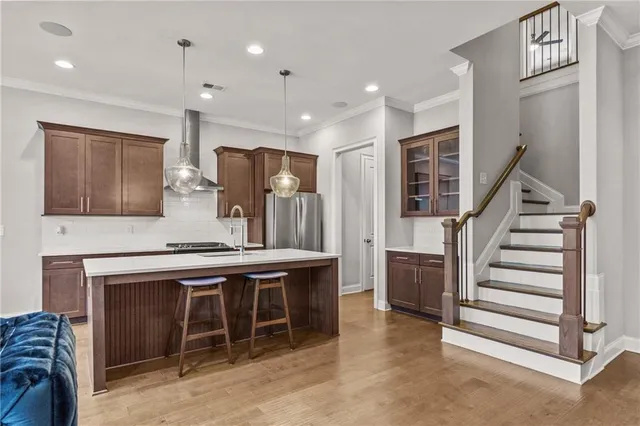 a kitchen with kitchen island a stove a sink and a refrigerator