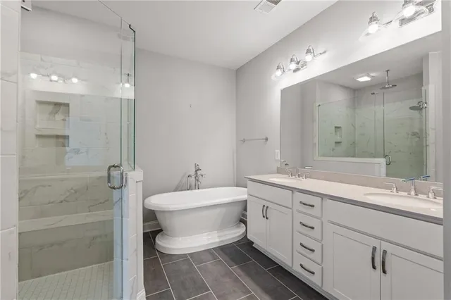 a bathroom with a double vanity sink mirror and toilet