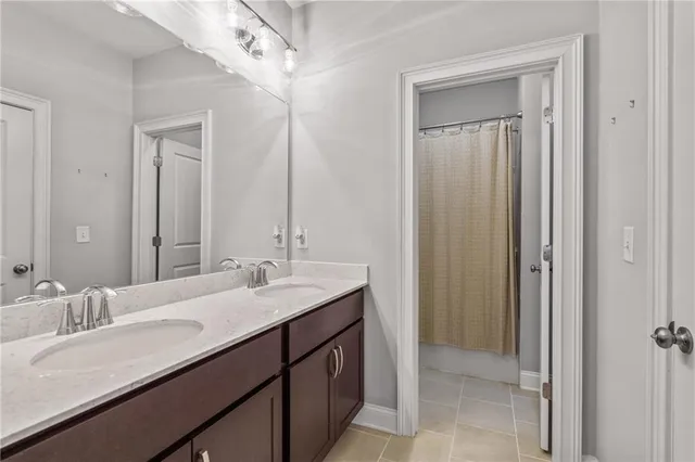 a bathroom with a double vanity sink and a mirror