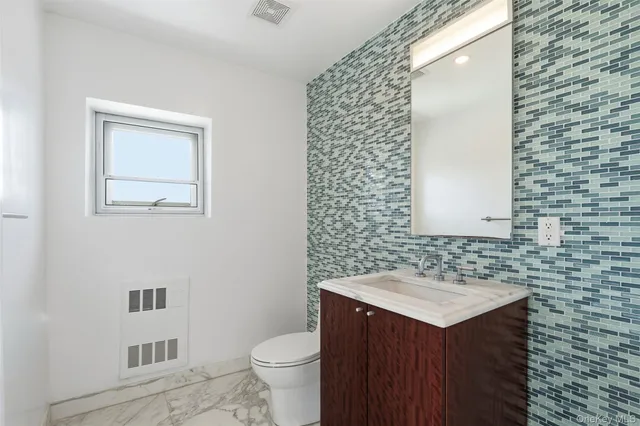 a large kitchen with stainless steel appliances granite countertop a lot of cabinets and wooden floor