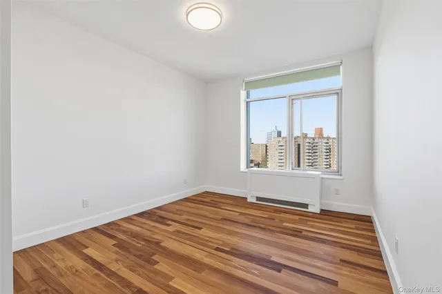 a view of a room with wooden floor and white walls