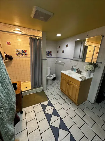 a bathroom with a sink a mirror and a shower