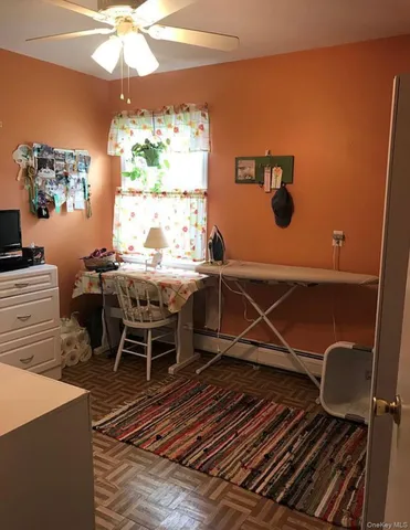 a view of a dining room with furniture a chandelier and wooden floor