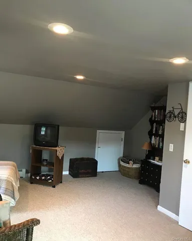 a living room with furniture and a lamp