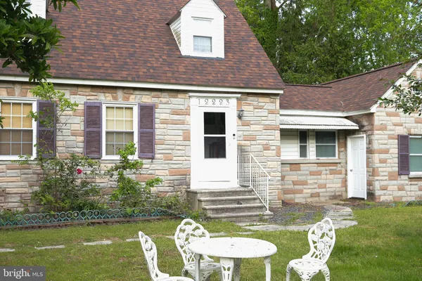 a front view of house with a garden