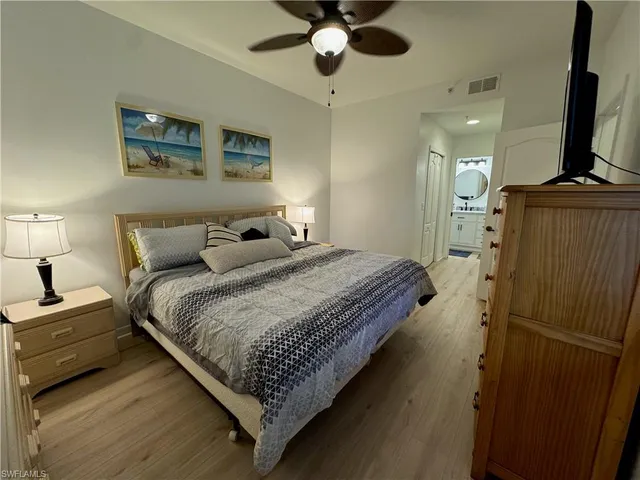 a bedroom with bed and a chandelier