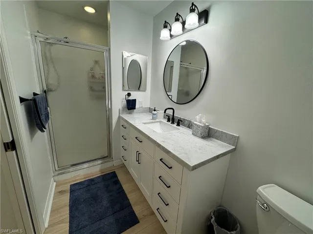 a bathroom with a sink a toilet and a mirror