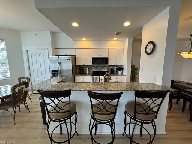 a kitchen with a table and chairs