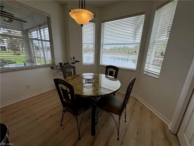 a view of a dining room with furniture and window
