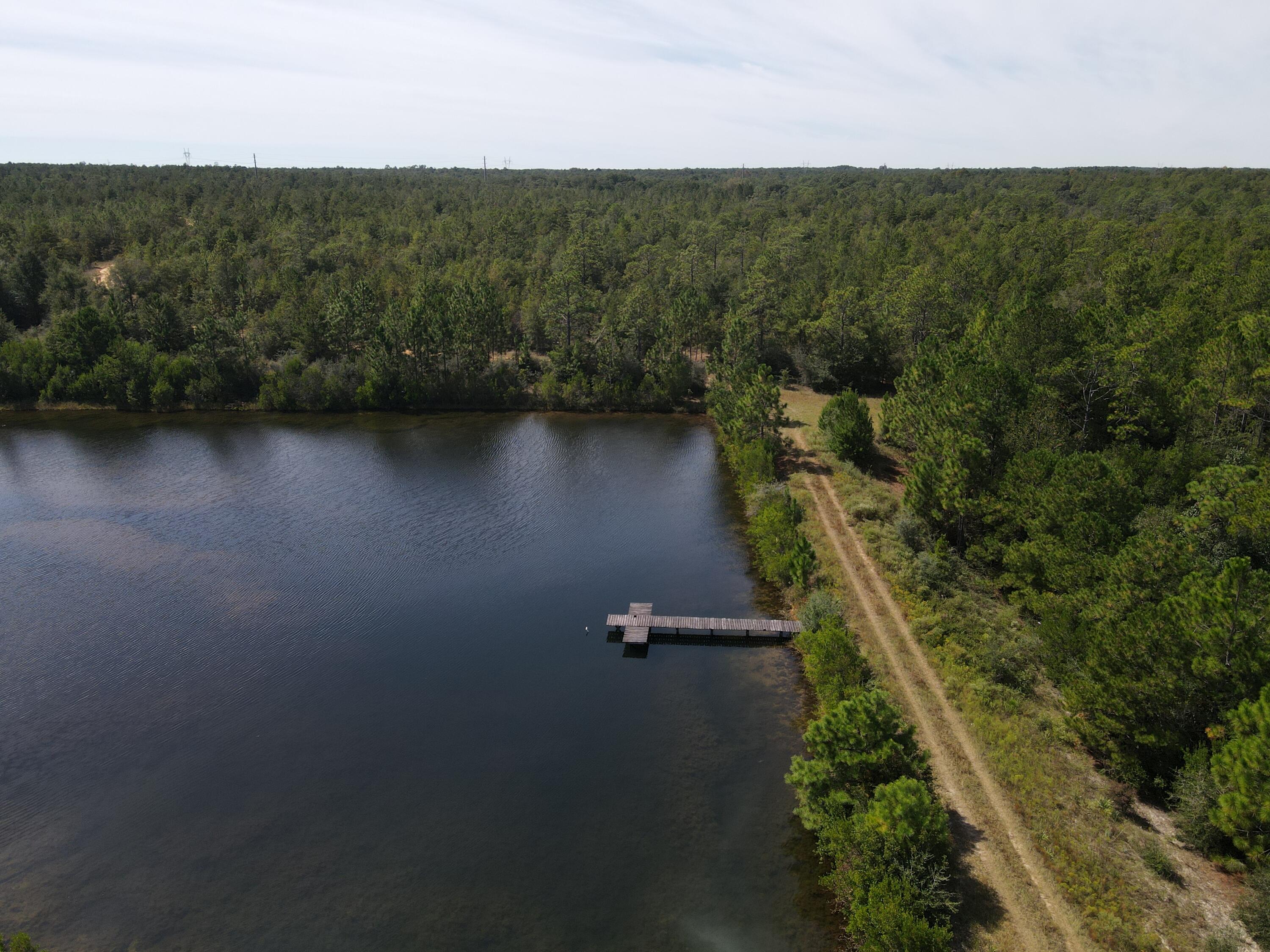 2450-acres King Lake Road DeFuniak Springs, FL 32433 - Photo 3 of 44 an aerial view of residential house with outdoor space and trees all around