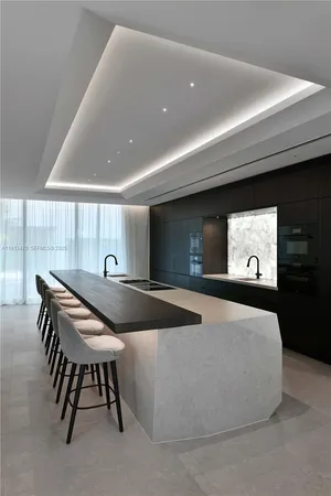 a dining room with furniture and kitchen view