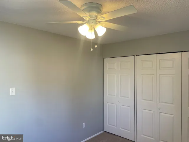 a view of a chandelier fan in a room