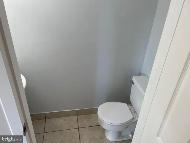 a white toilet sitting next to a shower