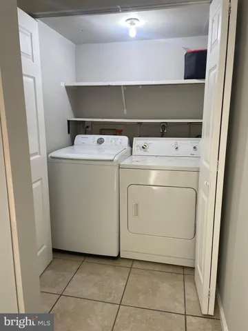 a view of washer and dryer with kitchen in the background