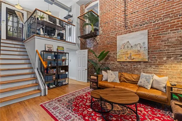 a view of a livingroom with furniture and staircase