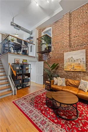 a living room with couch and a rug