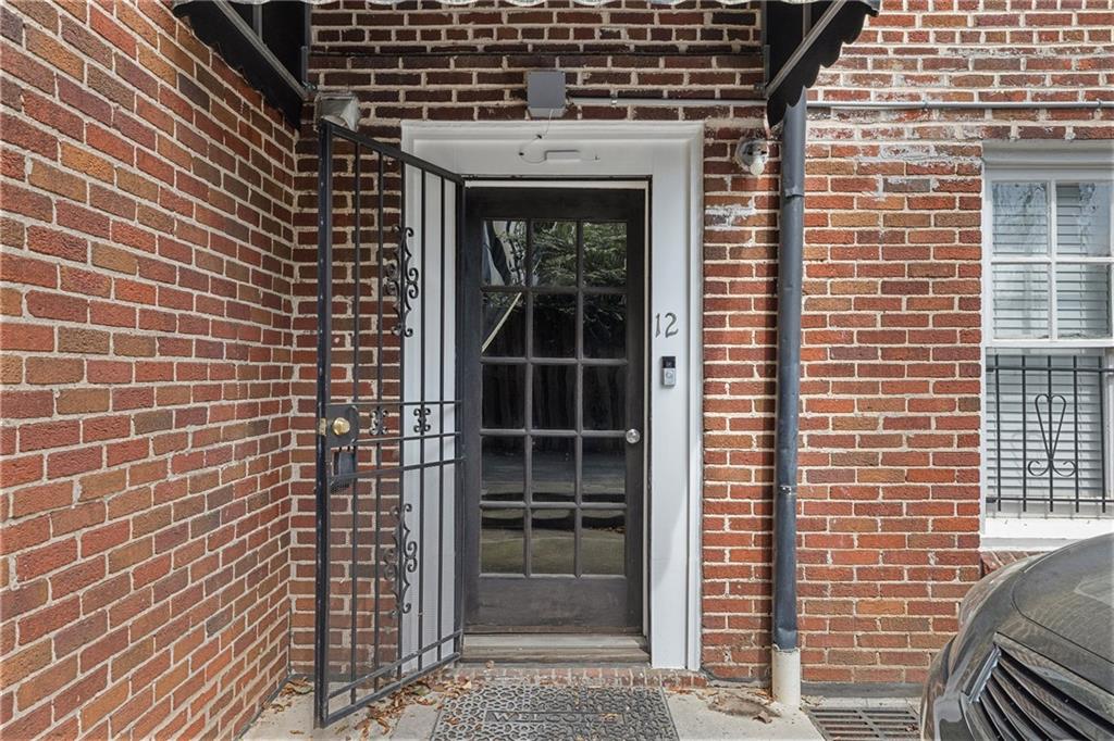 155 3rd Street Northeast, Unit 12 Atlanta, GA 30308 - Photo 2 of 36 a front view of a house with a window