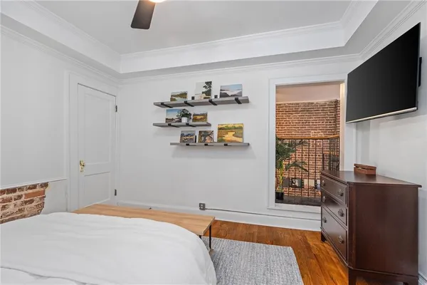 a bedroom with a bed and flat screen tv