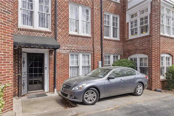a car parked in front of a brick building