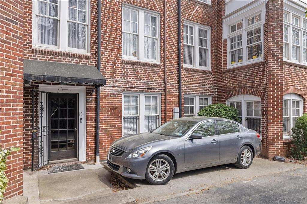 155 3rd Street Northeast, Unit 12 Atlanta, GA 30308 - Photo 29 of 36 a car parked in front of a brick building