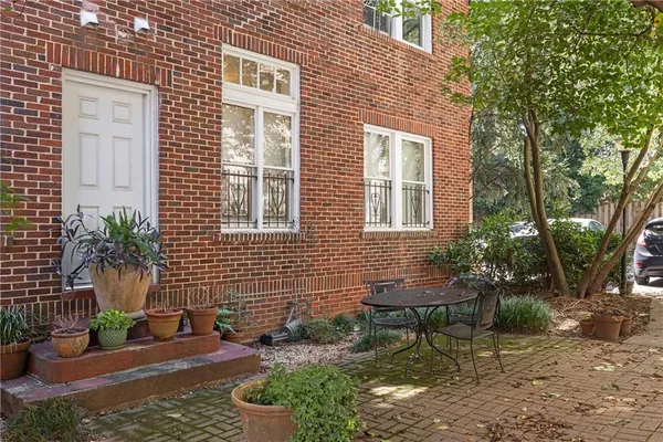 a view of a chairs and table in backyard of the house
