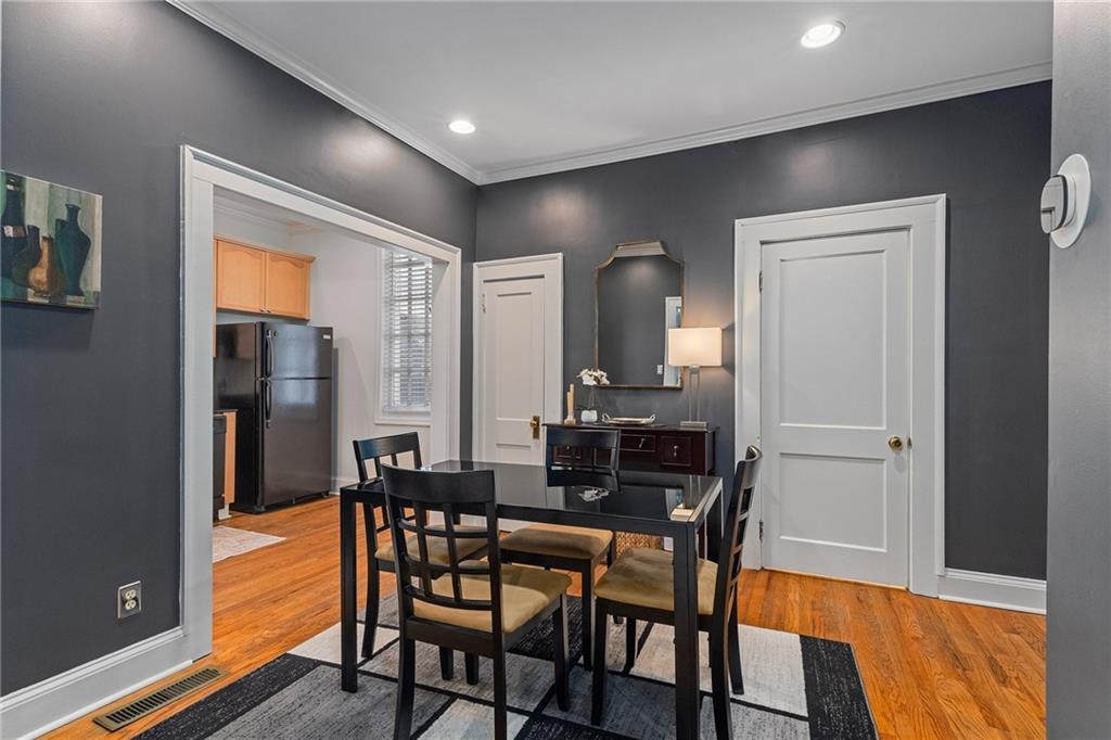 155 3rd Street Northeast, Unit 12 Atlanta, GA 30308 - Photo 6 of 36 a view of a dining room with furniture and wooden floor