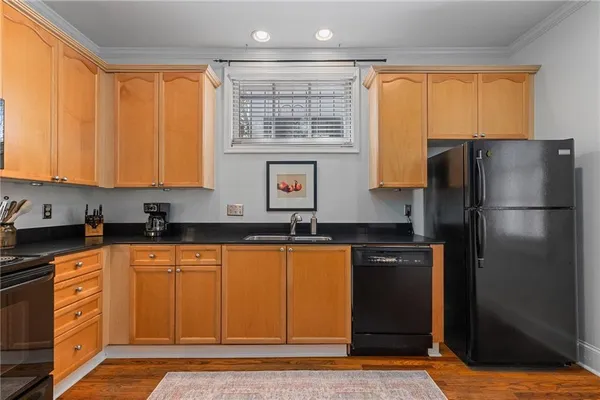 a kitchen with stainless steel appliances granite countertop a refrigerator and a sink