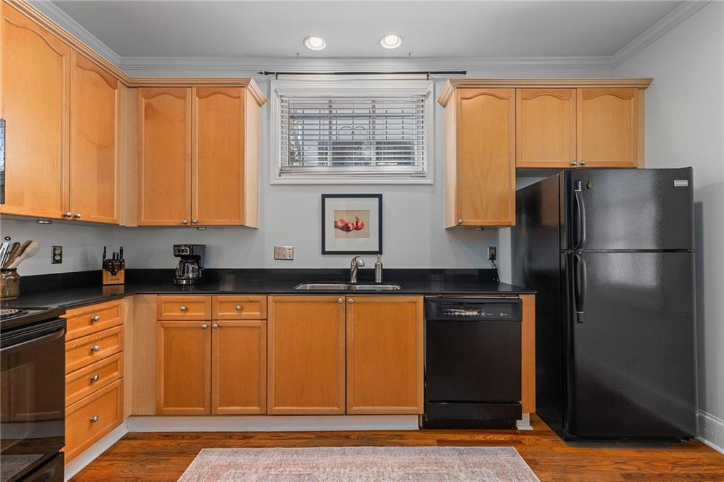 155 3rd Street Northeast, Unit 12 Atlanta, GA 30308 - Photo 7 of 36 a kitchen with stainless steel appliances granite countertop a refrigerator and a sink