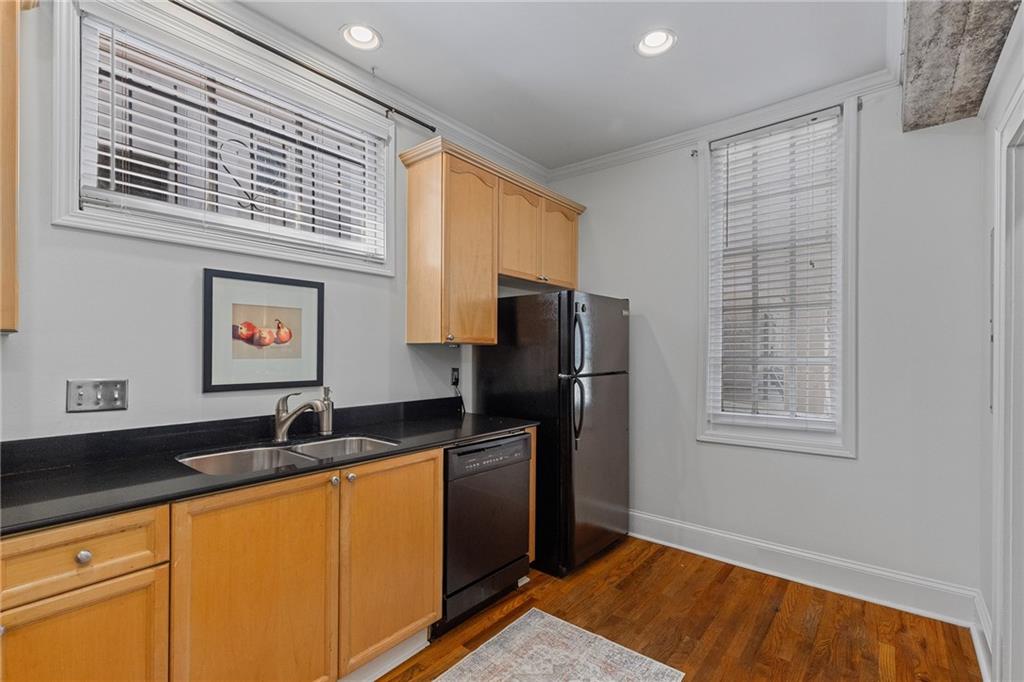 155 3rd Street Northeast, Unit 12 Atlanta, GA 30308 - Photo 10 of 36 a kitchen with stainless steel appliances granite countertop a refrigerator and a sink