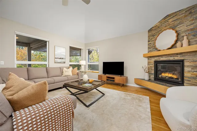 a living room with furniture a fireplace and a flat screen tv