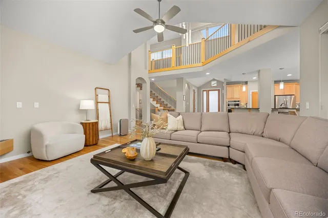 a living room with furniture a rug and a chandelier