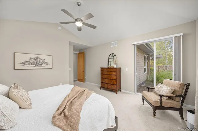 a bedroom with furniture and a large window