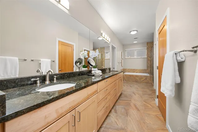 a large bathroom with a tub and sink