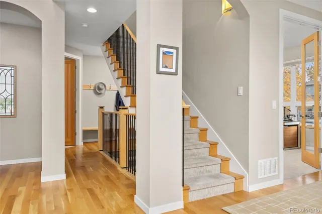 a view of a hallway with wooden floor and entryway
