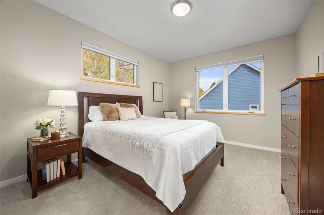 a bedroom with a bed and painting on the wall