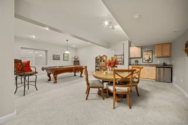 a dining room with furniture and a rug
