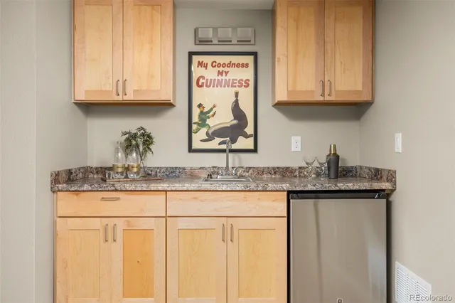 a kitchen with granite countertop stainless steel appliances white cabinets and a sink