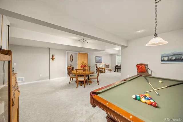 a room with furniture and pool table