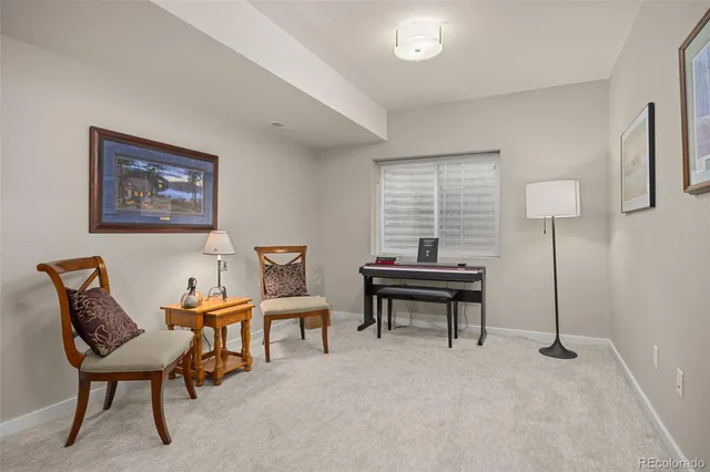 a bedroom with furniture and a lamp