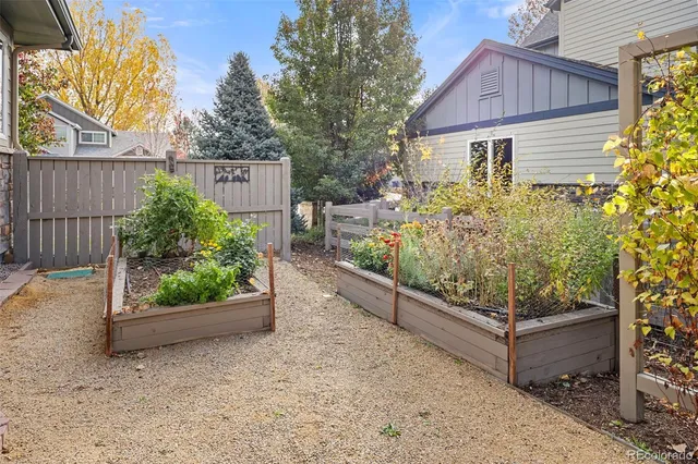a view of a house with wooden fence