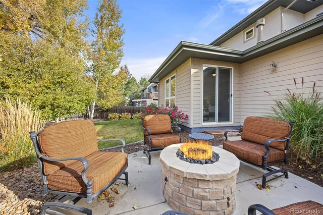 a backyard of a house with barbeque oven table and chairs