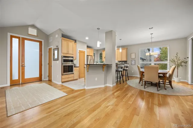 a living room with stainless steel appliances kitchen island granite countertop furniture and a kitchen view