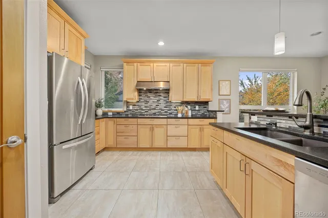 a kitchen with stainless steel appliances a refrigerator sink and cabinets