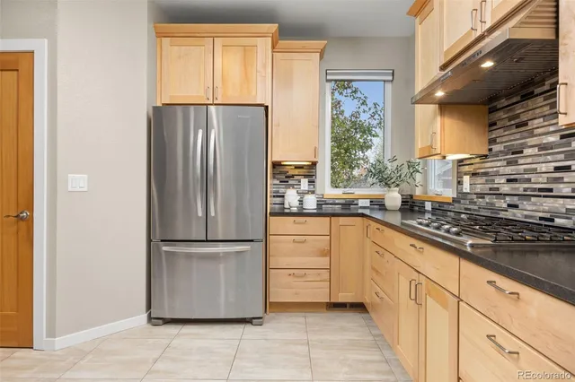 a kitchen with a refrigerator and a sink