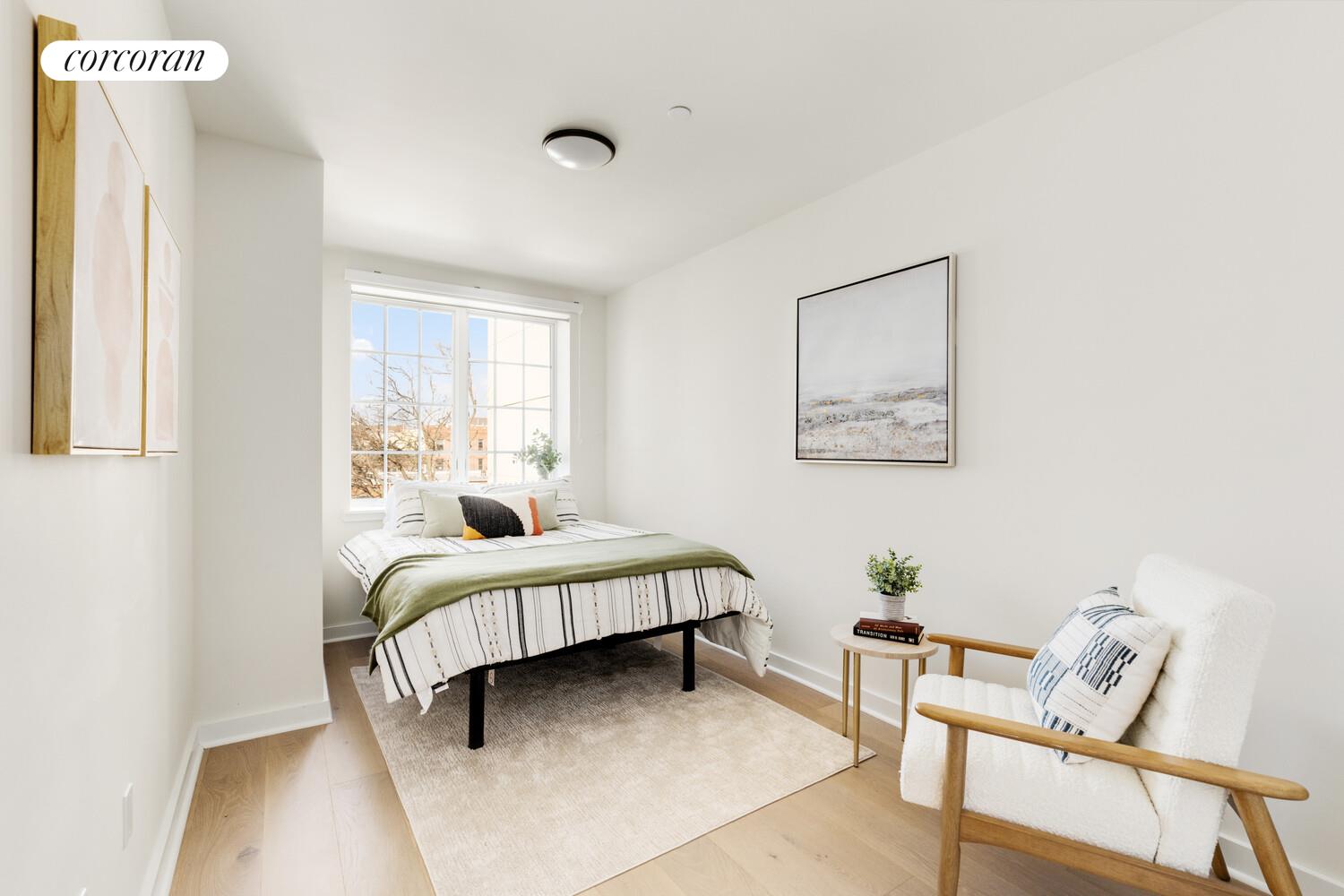 23-23 30th Road, Unit 4C Queens, NY 11102 - Photo 5 of 10 a bedroom with a bed and wooden floor