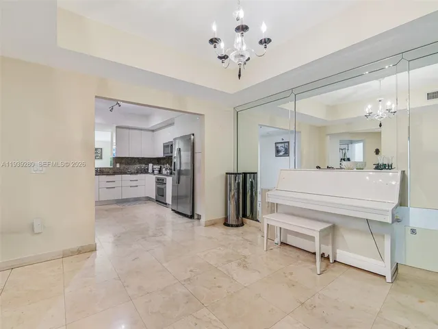 a view of a livingroom with a chandelier fan and entryway