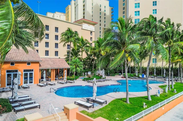 a swimming pool with outdoor seating and yard
