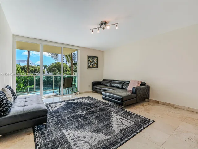 a living room with furniture and a rug