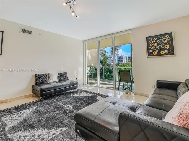 a living room with furniture and a floor to ceiling window